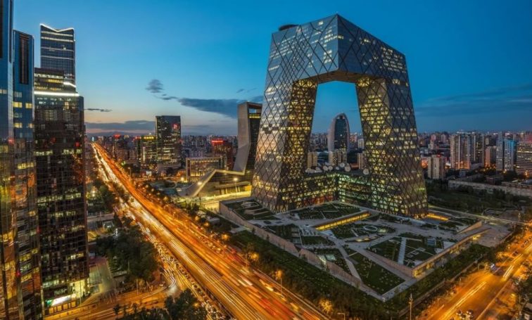 Beijing skyline at dusk with illuminated modern skyscrapers and the distinctive CITIC Tower architectural landmark