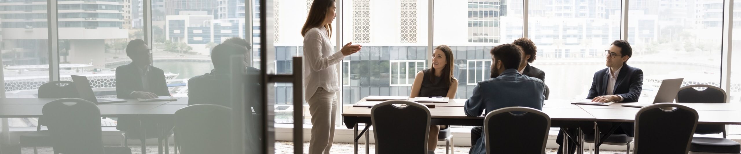 Professional team collaborating in a modern high-rise office with city skyline views