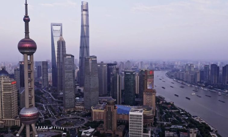 Shanghai skyline at dusk with Oriental Pearl Tower and Huangpu River