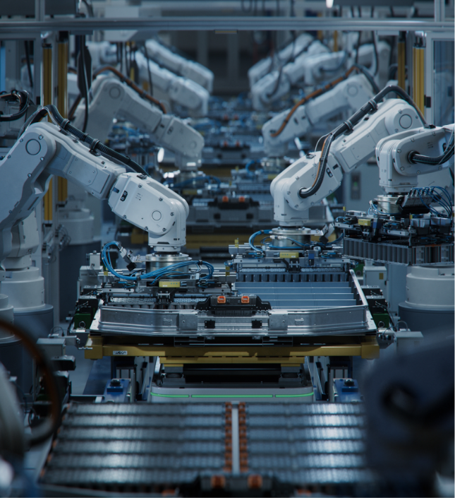 Automated robotic arms assembling automotive components on a manufacturing assembly line