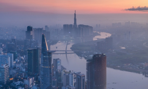 Ho Chi Minh City skyline at dawn with rivers and modern skyscrapers under pink sky